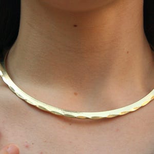Handcrafted golden brass choker with a Celtic and Viking-inspired design. This rigid collar is both strong and feminine — perfect for warrior spirits and lovers of brutalist, minimalist jewelry. Comfortable to wear and fits effortlessly with any outfit.