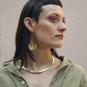 A bold golden brass collar inspired by Celtic warriors and Norse mythology. This rigid choker is lightweight and comfortable, making it perfect for everyday wear or special occasions. A statement piece for lovers of ancient symbolism.