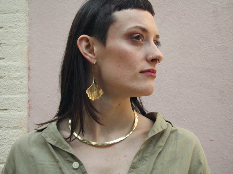 A bold golden brass collar inspired by Celtic warriors and Norse mythology. This rigid choker is lightweight and comfortable, making it perfect for everyday wear or special occasions. A statement piece for lovers of ancient symbolism.