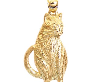 May include: A gold-colored cat charm pendant. The cat is sitting with its tail curled around its body. The charm is detailed with a textured fur pattern.