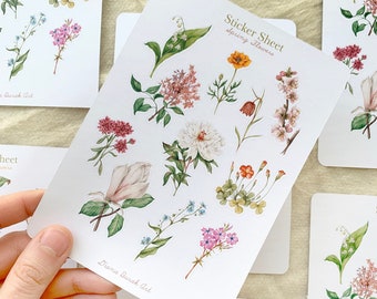 Pode incluir: Uma folha de adesivos com uma variedade de flores da primavera, incluindo magnólia, lilás, não-me-esqueças e lírios do vale. A folha é intitulada "Sticker Sheet Spring Flowers" e é de Diane Barcak Art.