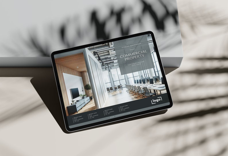 May include: A tablet displaying a website for commercial property. The website features a photo of a modern office space with a large window and a conference table. The text "COMMERCIAL PROPERTY" is displayed in a black box at the top of the page.