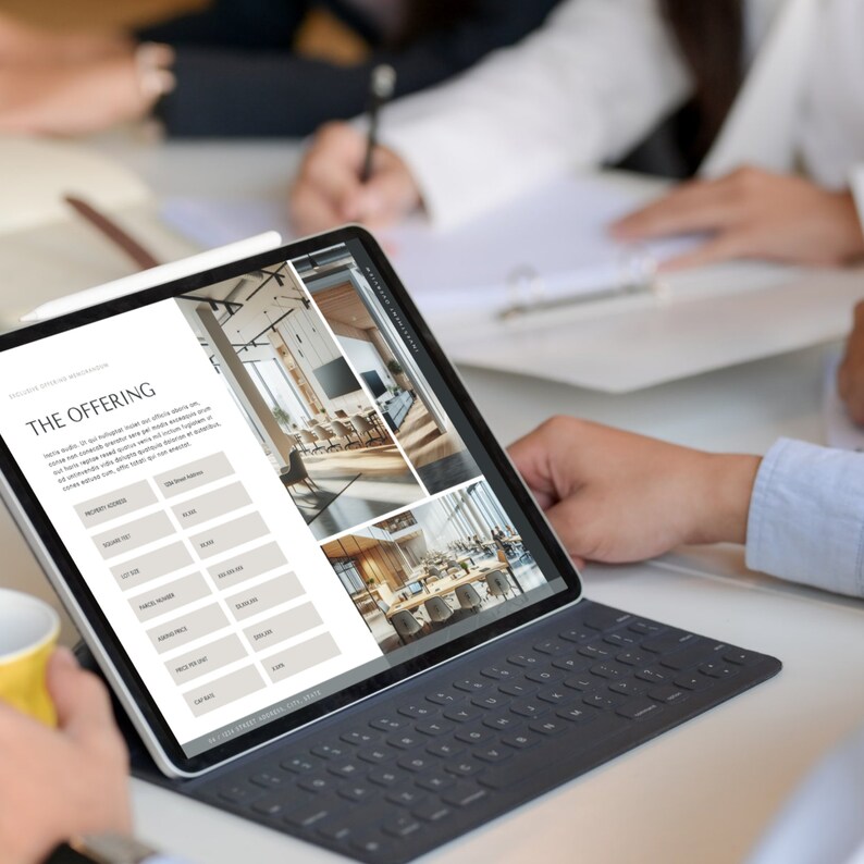 May include: A tablet computer displaying a website with images of a modern office space and a table with a list of features and pricing. The text on the screen reads "THE OFFERING".