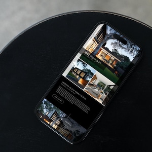 May include: A mobile phone screen displaying a real estate listing for a modern oceanfront estate located at 1234 Onyx Way. The listing features photos of the home's exterior and interior.