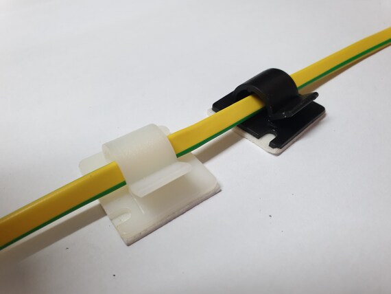 Sticky pad outlet cable clips