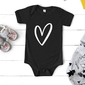 May include: Black baby onesie with a white hand-drawn heart design.