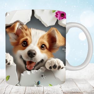 May include: White ceramic mug with a colorful image of a puppy peeking out of a hole in the mug. The puppy has brown and white fur and is smiling.
