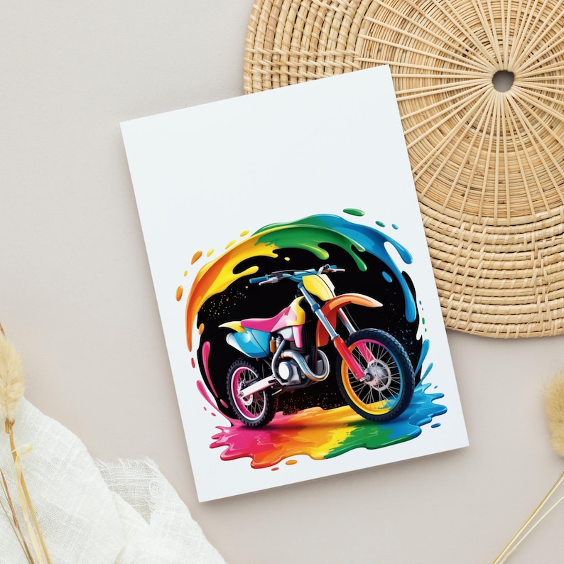 May include: A colorful illustration of a motocross bike with a rainbow splash effect. The bike features pink, yellow, orange, and blue accents. The background is black with a rainbow arc. The image is on a white card.