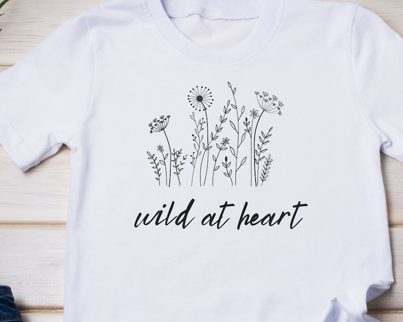 May include: White t-shirt with a black line drawing of wildflowers and the text "wild at heart".