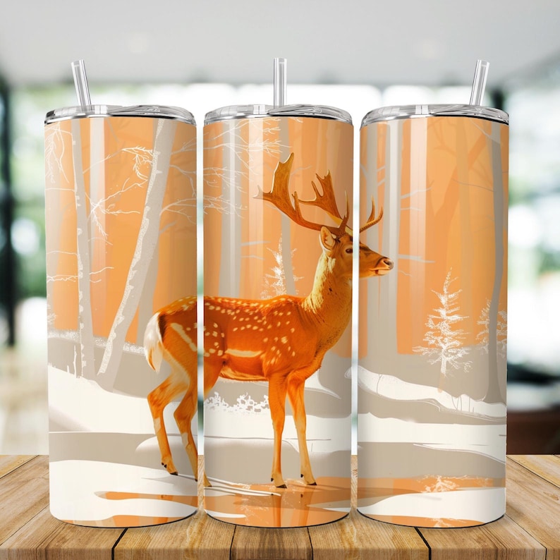 May include: Three stainless steel tumblers with a white and orange deer design. The deer is standing in a snowy forest scene.