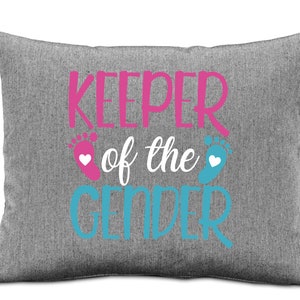 May include: Grey pillow with the text "Keeper of the Gender" in pink and blue with a pink and blue footprint on either side of the text.