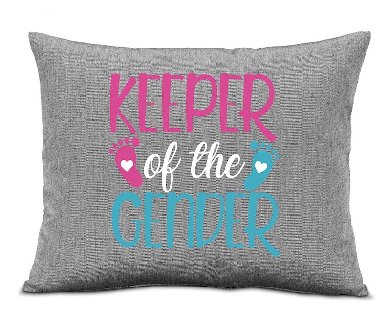 May include: Grey pillow with the text "Keeper of the Gender" in pink and blue with a pink and blue footprint on either side of the text.