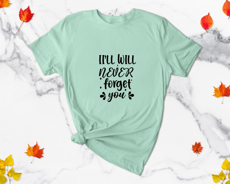May include: A light green t-shirt with the text "I'll will never forget you" in black.