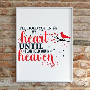 May include: White framed print with a red cardinal bird on a branch with red berries. The text reads "I'll hold you in my heart until I can hold you in heaven".