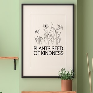 May include: Black and white framed print with a drawing of wildflowers and the text "Plants Seed of Kindness".