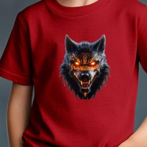 May include: A red t-shirt with a black wolf head graphic. The wolf has glowing orange eyes and a tribal design on its face.