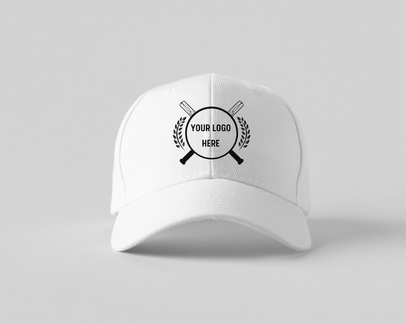 May include: White baseball cap with a black logo featuring crossed baseball bats, a circle with the text "YOUR LOGO HERE" and a laurel wreath.