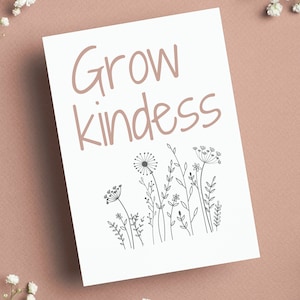 May include: White card with the text "Grow kindness" in black script font. The card is decorated with a black line drawing of a field of wildflowers.