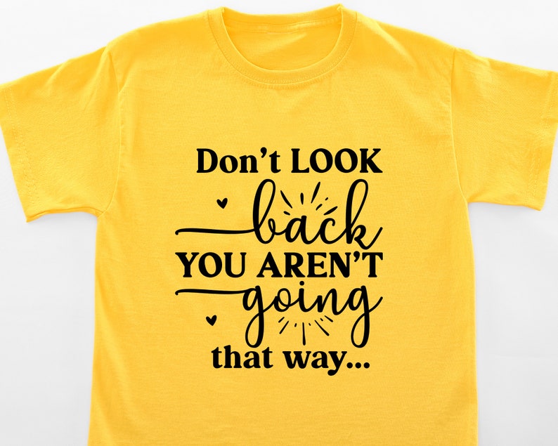 May include: Yellow t-shirt with black text that reads "Don't LOOK back YOU AREN'T going that way..."