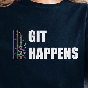 May include: Black t-shirt with a white graphic that says "GIT HAPPENS" and a colourful abstract design.