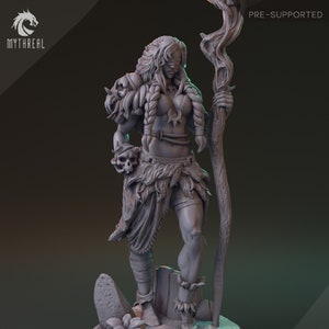 May include: A gray 3D printed miniature of a female warrior with a skull in one hand and a staff in the other. She is wearing a fur skirt and a leather bra. The miniature is pre-supported.