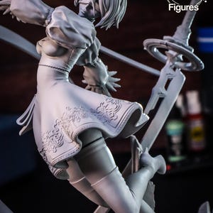 May include: A white plastic figurine of a female character with short white hair, wearing a white dress and holding a sword. The figurine is posed in a dynamic action pose, with one leg raised and the other bent. The figurine is set against a dark background.