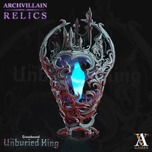 May include: A silver and black ornate frame with a blue crystal inside. The frame is shaped like a castle and has a gothic design. The text "The Unburied King" is at the bottom of the image.