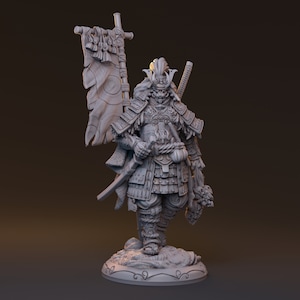 May include: A gray painted miniature figurine of a samurai warrior wearing armor and holding a sword and a severed head. The samurai is standing on a base with a decorative design. The samurai is wearing a helmet with a mask and has a long beard.