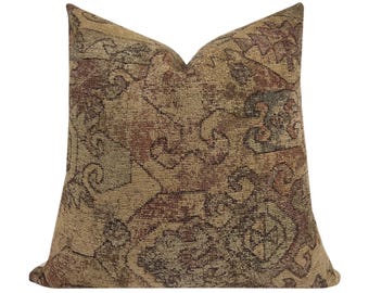 May include: A decorative throw pillow with a brown, beige, and red patterned design. The pillow has a square shape and a soft, textured fabric.