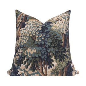 May include: A decorative throw pillow with a tapestry-style design featuring a forest scene with trees in shades of green, blue, and brown.
