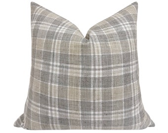 May include: A gray and beige plaid throw pillow with a square shape.