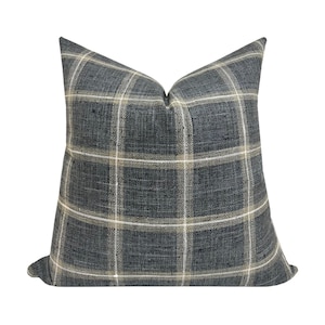 May include: A blue and cream plaid throw pillow with a soft, textured fabric.