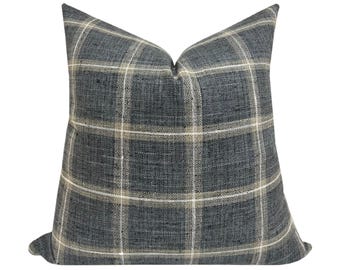 May include: A blue and cream plaid throw pillow with a soft, textured fabric.