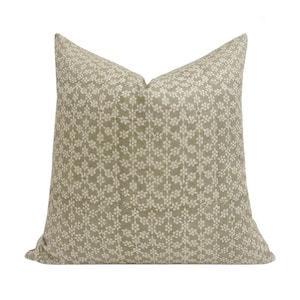 May include: A green and white patterned throw pillow with a floral design.