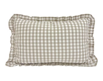May include: A beige and white gingham pillow with a ruffled edge.