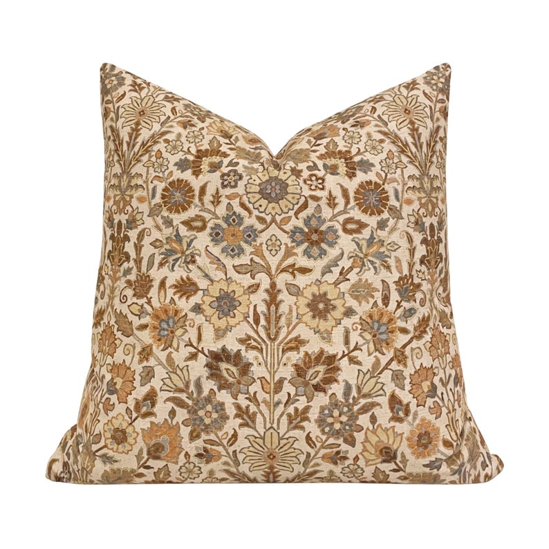 May include: A decorative throw pillow with a floral pattern in shades of brown, beige, and gray. The pillow has a square shape and a soft, textured fabric.