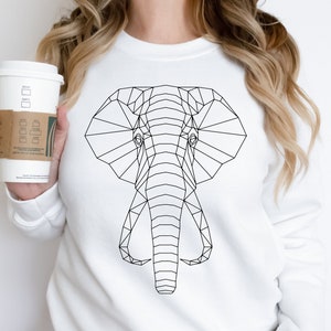 May include: A white sweatshirt with a geometric black elephant design on the front.