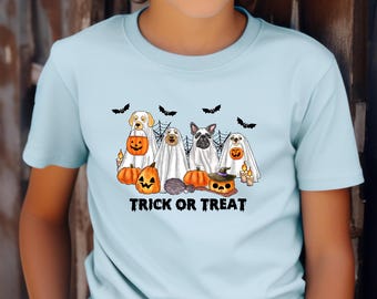 May include: Pale blue t-shirt with a Halloween-themed graphic. The design shows four dogs in ghost costumes, pumpkins, bats, and the words "TRICK OR TREAT". The illustration is colourful and festive.
