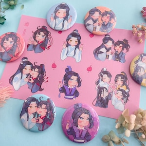 May include: A collection of colorful anime-style pinback buttons and stickers featuring various characters. The buttons are round and the stickers are rectangular, all with cute illustrations of anime characters in different poses. The background is pink and blue.