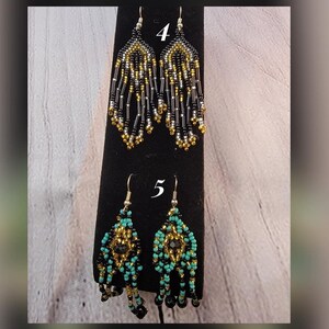 May include: Two pairs of beaded earrings. The first pair is black, gold, and silver. The second pair is turquoise, black, and gold. The earrings are labeled with the numbers 4 and 5.
