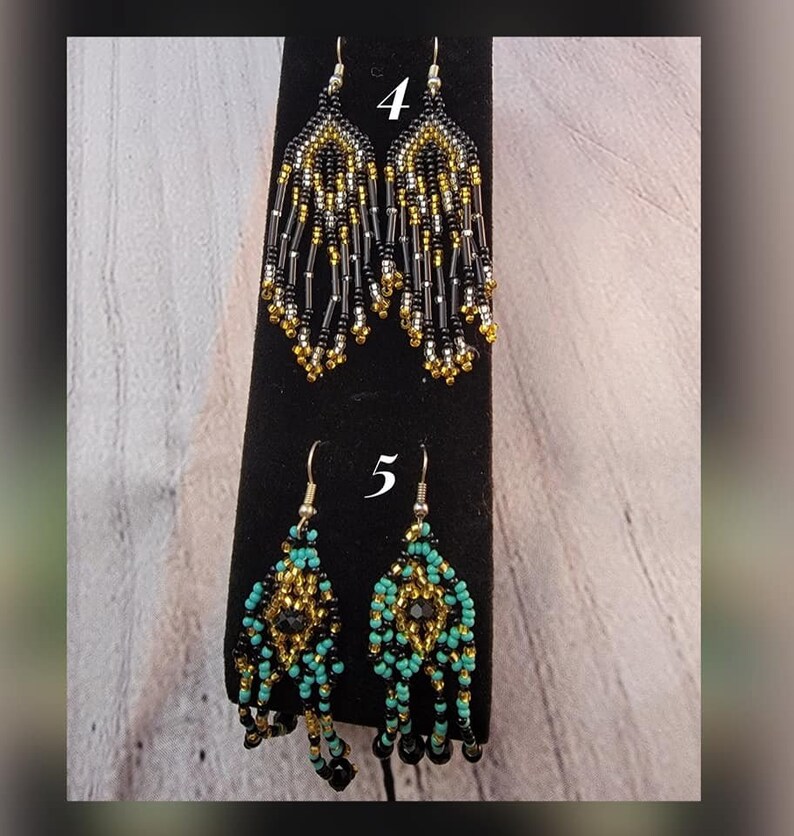 May include: Two pairs of beaded earrings. The first pair is black, gold, and silver. The second pair is turquoise, black, and gold. The earrings are labeled with the numbers 4 and 5.