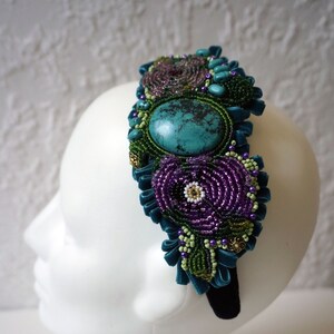 The headband decorated with natural turquoise cabochon and ethnic embroidery.