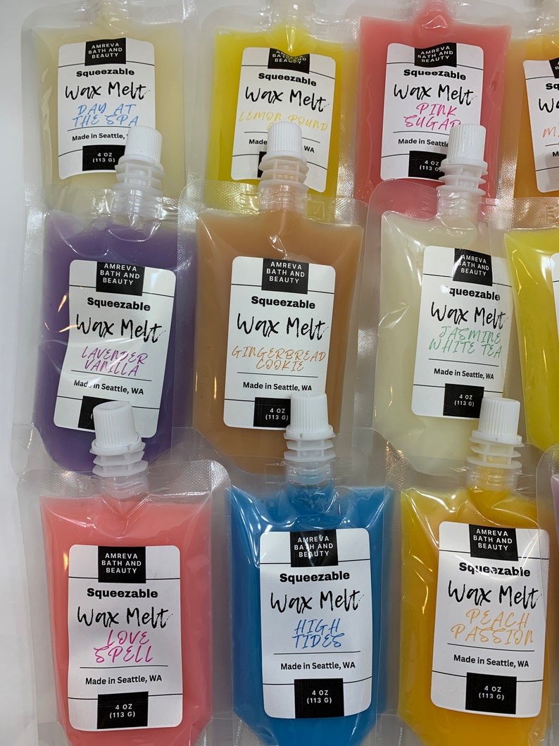 May include: An assortment of squeezable wax melts in various colors and scents, including "Day at the Spa," "Lemon Pound," and "Pink Sugar." Each pouch is labeled with the scent name and brand information. The pouches are 4 oz (113 g) each.