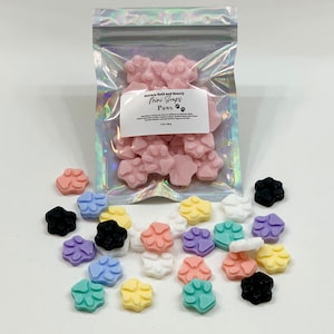 May include: A bag of small, colorful paw-shaped soaps. The bag is labeled "Amaya Bath and Beauty Mini Soaps Paws".