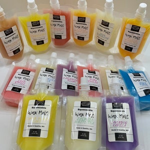 May include: An assortment of squeezable wax melts in various colors, each packaged in a clear pouch with a white cap. The pouches are labeled with scent names like "Sunshine," "Lavender Vanilla," and "High Tide." Each pouch contains 4 oz (113 g) of wax melt.