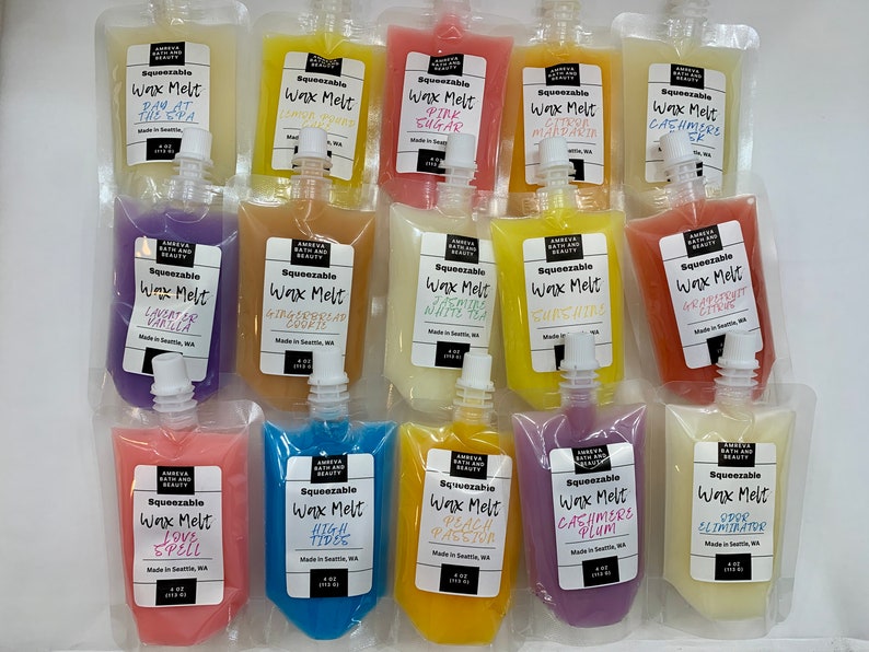 May include: Assortment of squeezable wax melts in various colors, including yellow, pink, purple, and orange. Each pouch is labeled with a scent name like "Pink Sugar" or "Lavender Vanilla". The pouches are 4 oz (113 g) each.