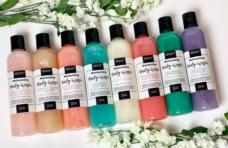 May include: Eight clear plastic bottles of body wash with black lids and white labels. The labels have the text "Moisturizing Body Wash" and the scent of each body wash. The scents are: "Sweet Water + Passion Fruit", "Vanilla & French Cream", "Tropical Fruit + Sugar Cane", "Coconut + Key Lime", "Milk + Honey", "Raspberry + White Musk", "Cacahuate + Watermelon", and "Lavender + Oatmilk".