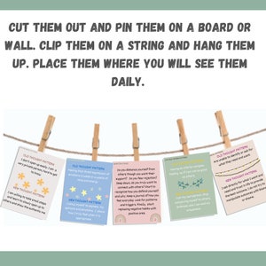 May include: A set of colorful cards with positive affirmations and thought patterns. The cards are hanging on a string with clothespins. The text on the cards includes phrases like "I am willing to take small steps" and "I ask directly for what I want".