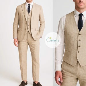 May include: A three-piece tan linen suit with a matching waistcoat, jacket, and trousers. The suit is paired with a white dress shirt and a black tie. The suit is a classic style, suitable for formal or semi-formal occasions.