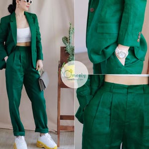 May include: A green linen trouser suit with a blazer and matching trousers. The suit is tailored and has a classic style.